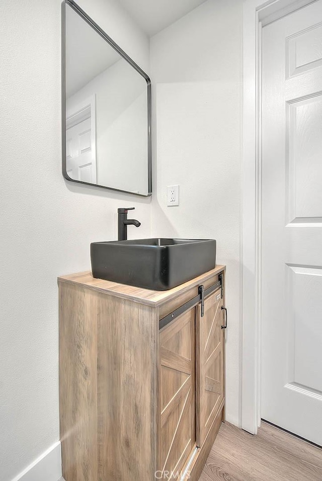 bathroom with vanity and hardwood / wood-style flooring