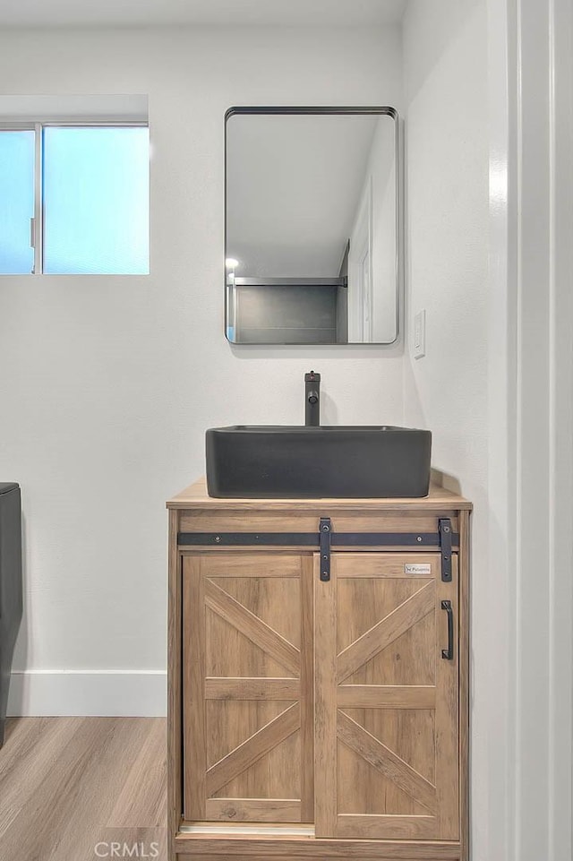 bathroom with wood-type flooring and vanity