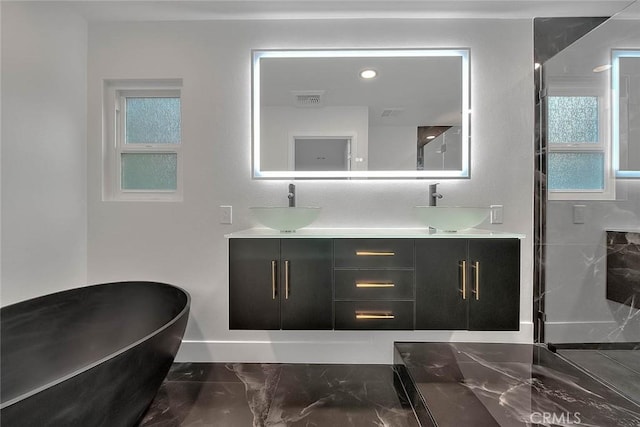 bathroom featuring a tub to relax in and vanity