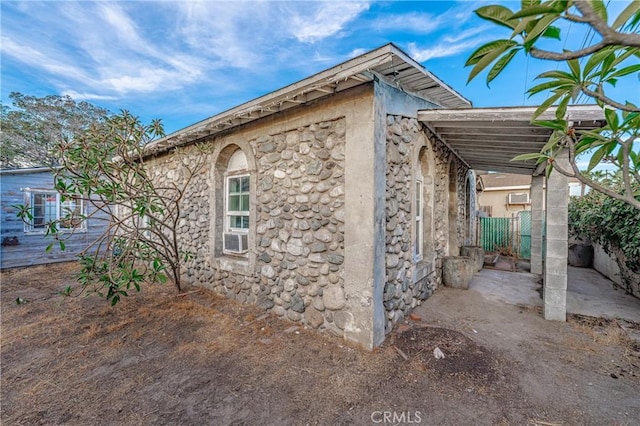 view of property exterior with a carport