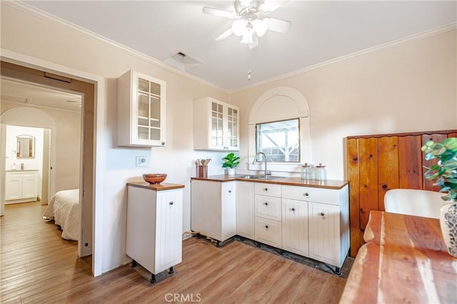 kitchen featuring sink, light hardwood / wood-style flooring, and white cabinets