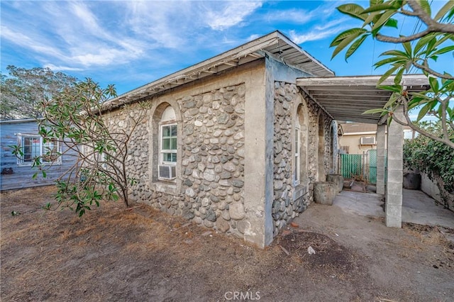 view of property exterior with a carport