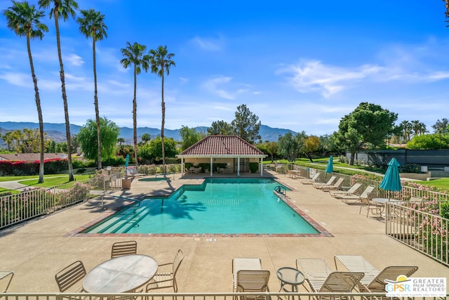 view of pool featuring a mountain view and a patio area