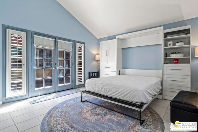 tiled bedroom featuring vaulted ceiling and french doors