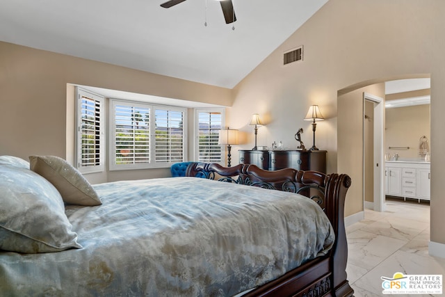 bedroom with ceiling fan, connected bathroom, and vaulted ceiling