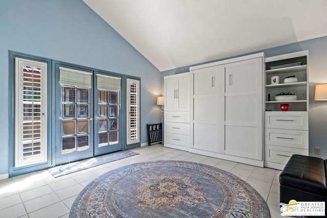 interior space featuring vaulted ceiling, french doors, and light tile patterned floors