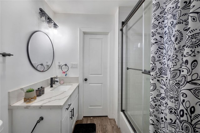 bathroom featuring shower / bath combination with glass door, vanity, and hardwood / wood-style flooring