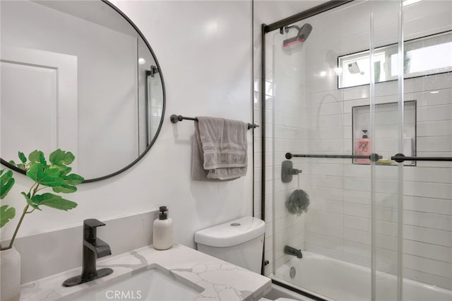 full bathroom with shower / bath combination with glass door, vanity, and toilet