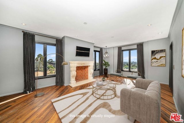 living room with wood-type flooring and ornamental molding