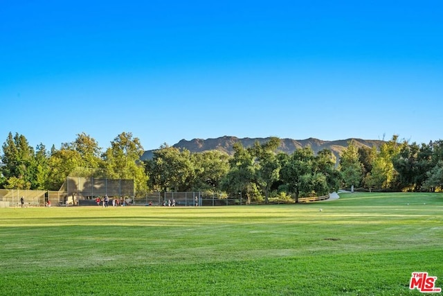 surrounding community featuring a yard and a mountain view