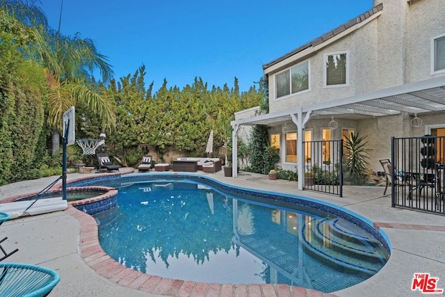 view of pool with an in ground hot tub and a patio area