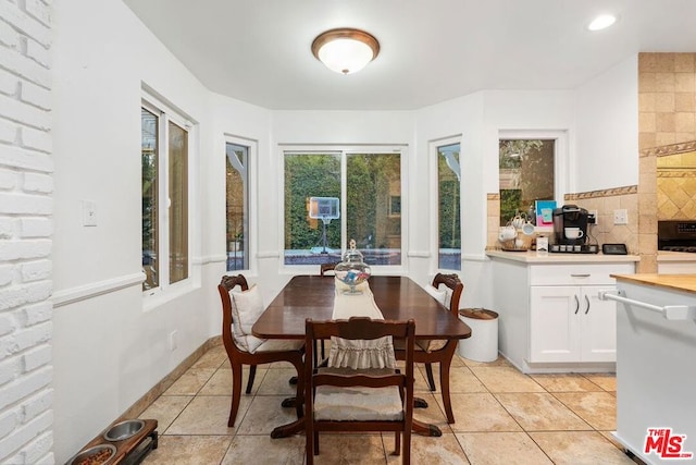 dining space featuring light tile patterned floors