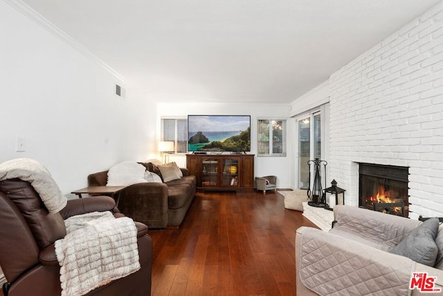 living room with a fireplace, ornamental molding, and dark hardwood / wood-style floors