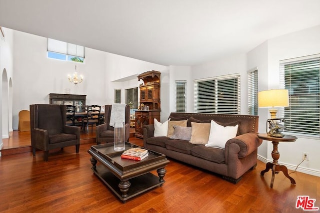 living room featuring wood-type flooring and a notable chandelier