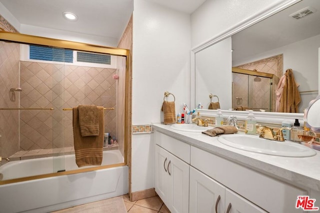 bathroom featuring vanity, tile patterned flooring, and combined bath / shower with glass door