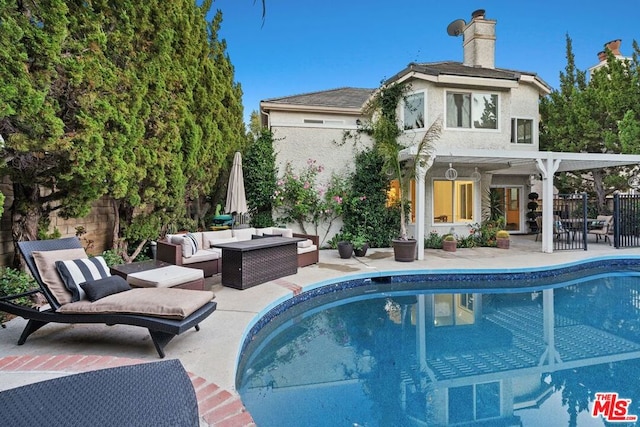 view of swimming pool with an outdoor living space and a patio area