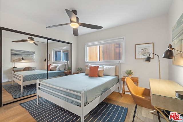 bedroom with ceiling fan, a closet, and light wood-type flooring