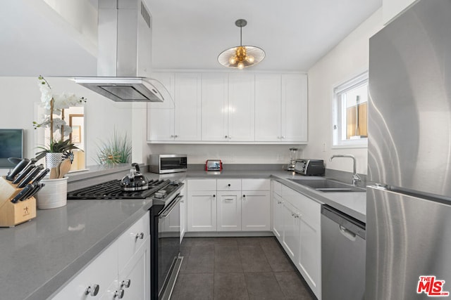 kitchen featuring stainless steel appliances, sink, exhaust hood, decorative light fixtures, and white cabinets