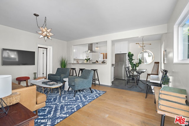 living room featuring light hardwood / wood-style floors and an inviting chandelier