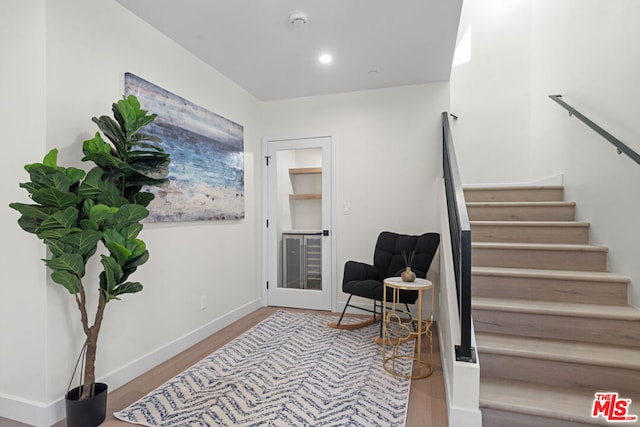 staircase with hardwood / wood-style floors and french doors