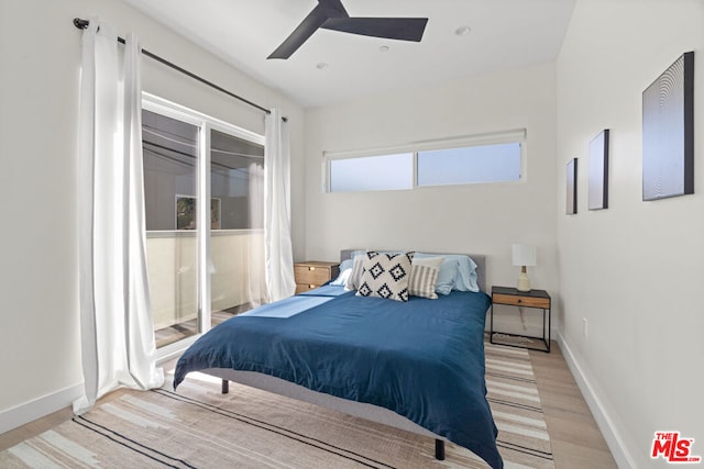 bedroom featuring multiple windows, ceiling fan, and light hardwood / wood-style floors