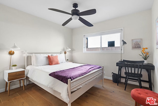 bedroom featuring dark hardwood / wood-style flooring and ceiling fan