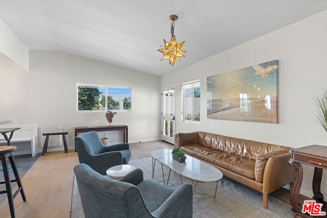 living room featuring light wood-type flooring and lofted ceiling