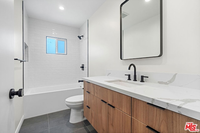 full bathroom with tile patterned flooring, vanity, toilet, and tiled shower / bath combo