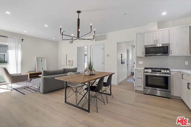 dining room featuring light hardwood / wood-style floors and a notable chandelier