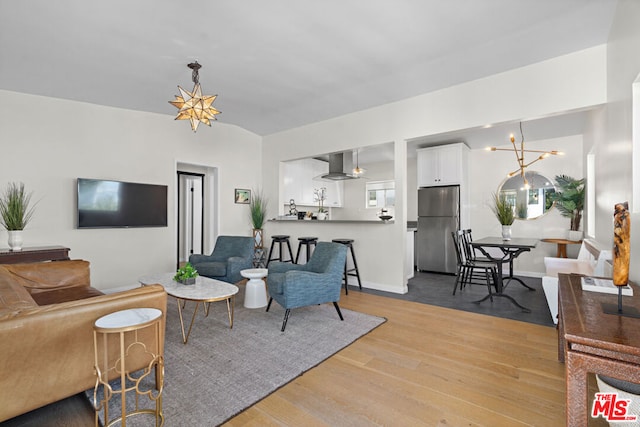 living room featuring a chandelier and light hardwood / wood-style flooring