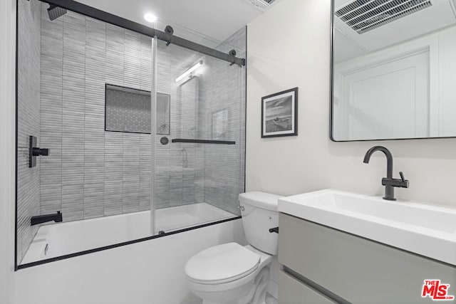 full bathroom featuring vanity, toilet, and enclosed tub / shower combo