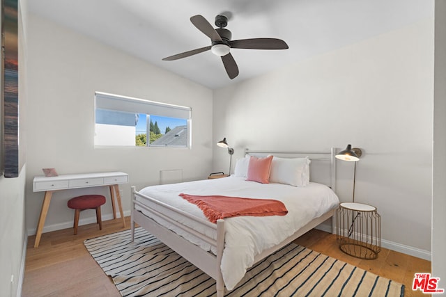 bedroom with hardwood / wood-style floors, ceiling fan, and lofted ceiling