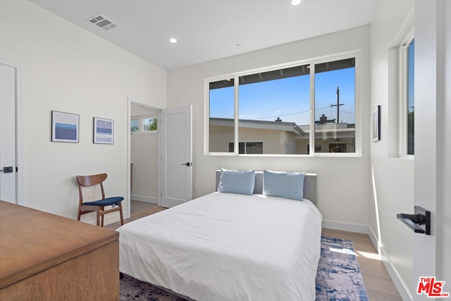 bedroom with wood-type flooring