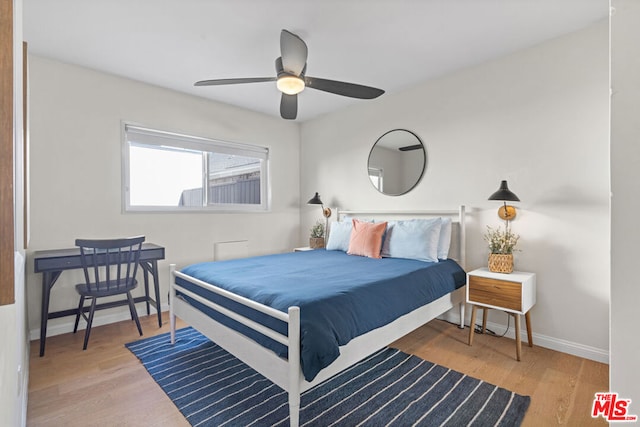 bedroom with hardwood / wood-style flooring and ceiling fan