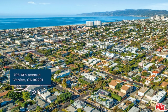 birds eye view of property featuring a water and mountain view