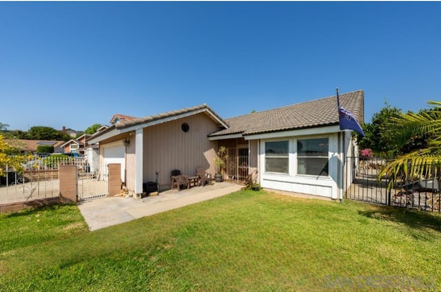 back of house featuring a patio and a yard