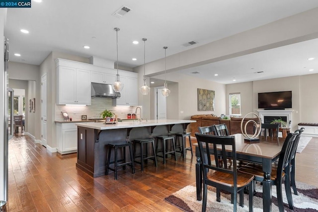 dining room with sink and dark hardwood / wood-style floors