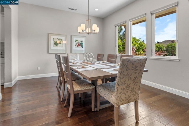 dining room featuring an inviting chandelier and dark wood-type flooring