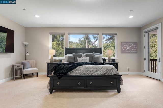 bedroom featuring light carpet and access to outside