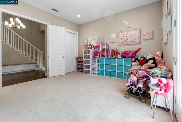 recreation room featuring a chandelier and carpet floors