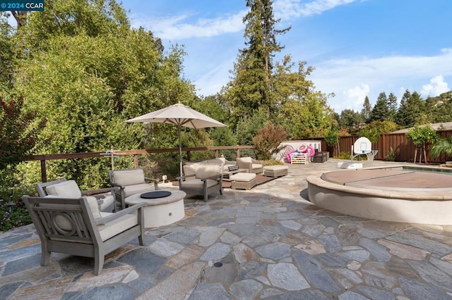 view of patio featuring an outdoor living space with a fire pit