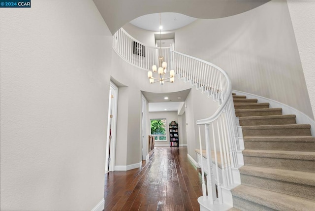 foyer featuring a chandelier, a high ceiling, and dark hardwood / wood-style floors