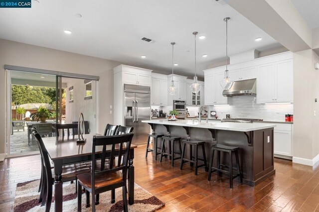 dining room with sink and dark wood-type flooring