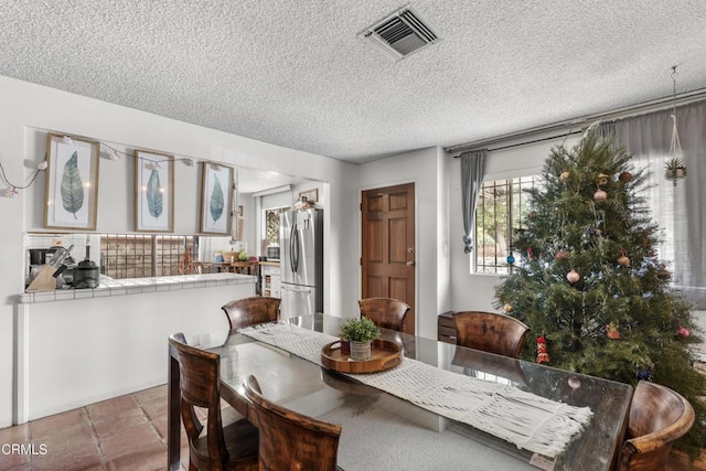 dining space with a textured ceiling