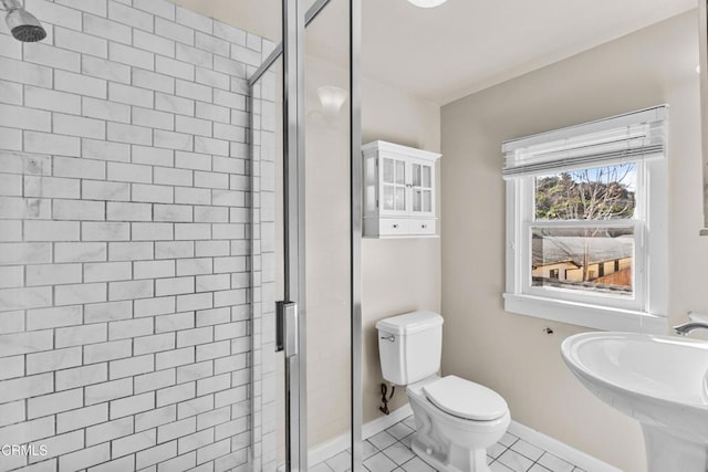 bathroom with toilet, tile patterned floors, walk in shower, and sink