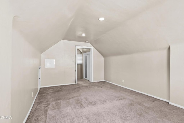 bonus room with carpet and vaulted ceiling