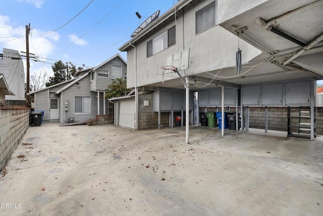 back of house featuring a garage