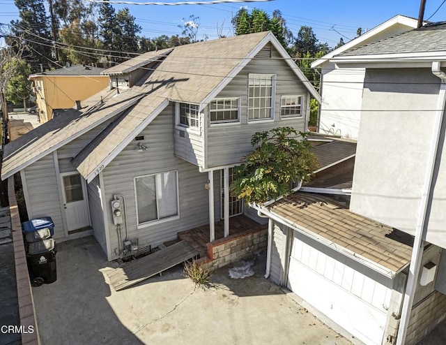 rear view of house featuring a garage