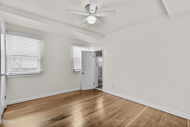 empty room featuring ceiling fan and hardwood / wood-style flooring