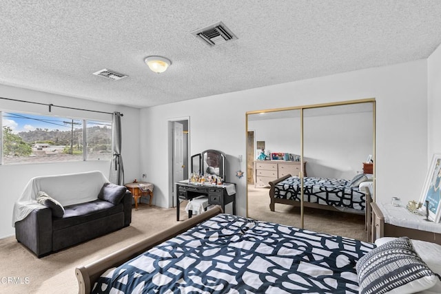 bedroom featuring a textured ceiling, a closet, and carpet flooring